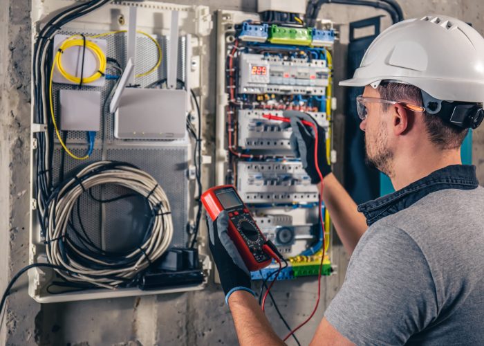 man-electrical-technician-working-switchboard-with-fuses (2) man-electrical-technician-working-switchboard-with-fuses (2)